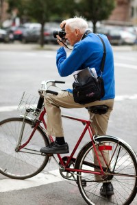 Bill Cunningham, famous for taking photos while on his bicycle.